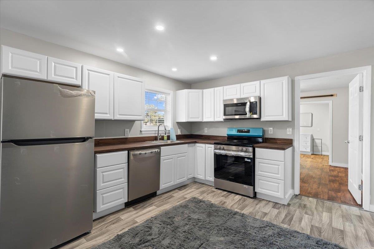 2030 South Main Street Covington, TN 38019 - Photo 7 of 27 a kitchen with granite countertop white cabinets and refrigerator
