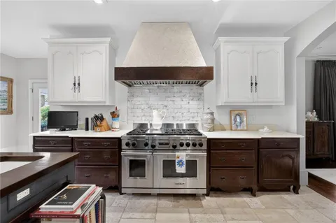 a large kitchen with a table and chairs