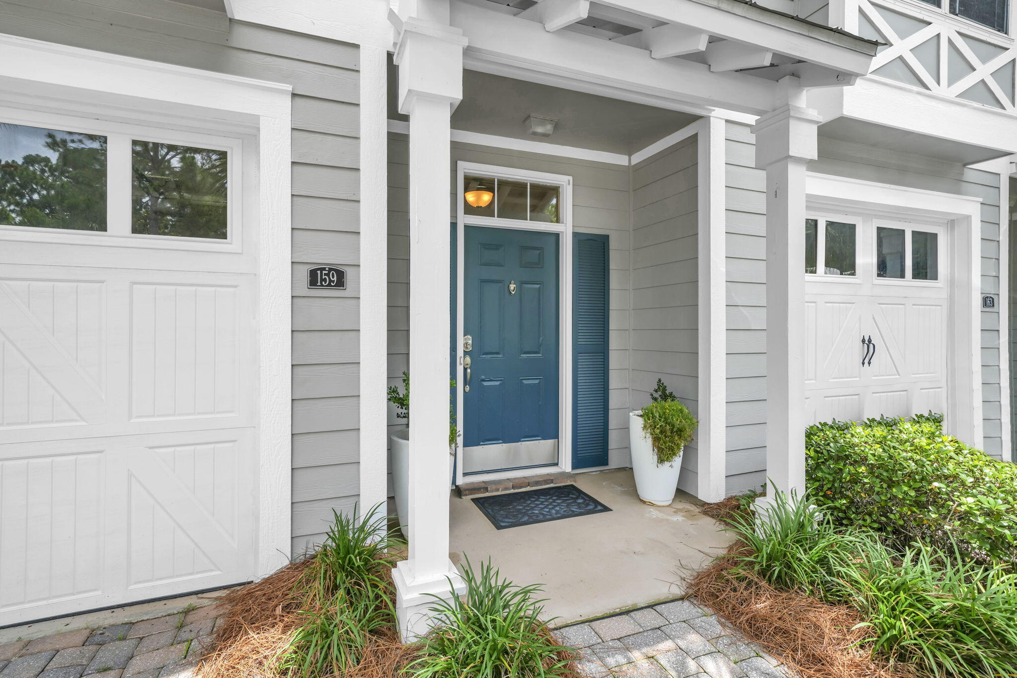 159 Golden Eagle Court, Unit 3C Santa Rosa Beach, FL 32459 - Photo 3 of 34 a view of a door of the house with potted plants