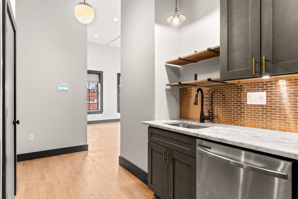 2 Washington Street Haverhill, MA 01832 - Photo 6 of 15 a kitchen with a sink and a mirror
