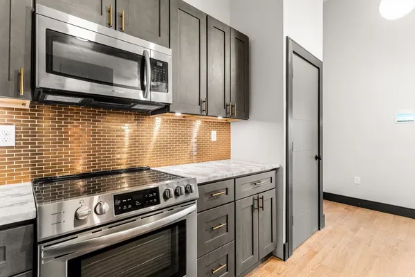 a kitchen with a stove and a microwave