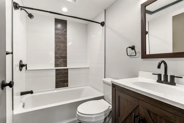 a bathroom with a sink a toilet and shower