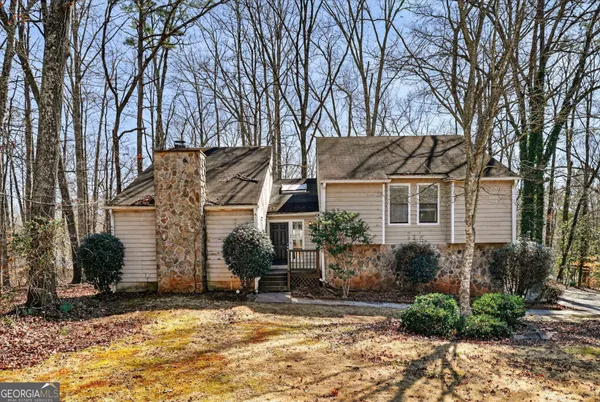 a view of a house with a yard covered in snow