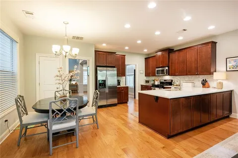 a view of a dining room with furniture wooden floor and chandelier