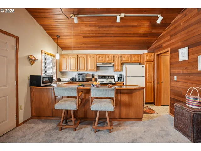 a kitchen with stainless steel appliances granite countertop a sink window and refrigerator