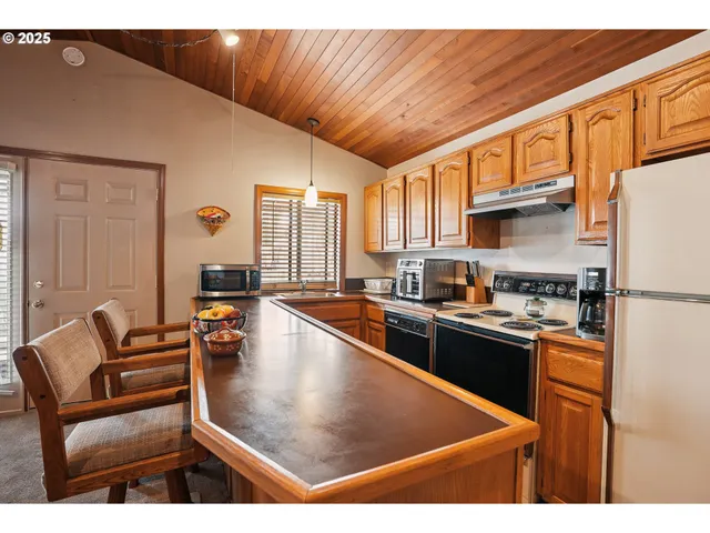 a kitchen with a sink a stove and cabinets
