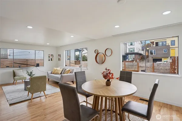 a view of a dining room with furniture window and wooden floor