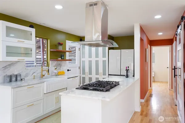 a kitchen with stainless steel appliances a stove a sink and a refrigerator