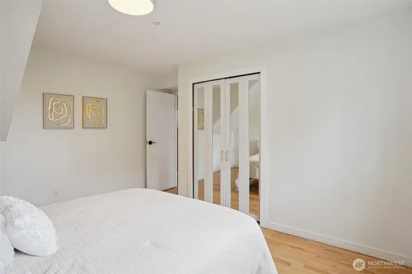 a bedroom with a bed and a wall painting