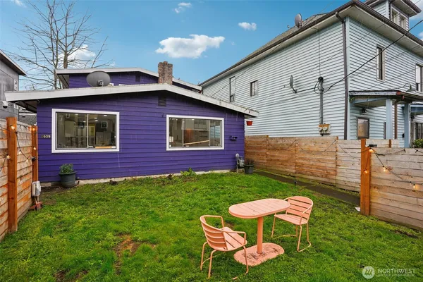 a brick house with table and chairs in front of it