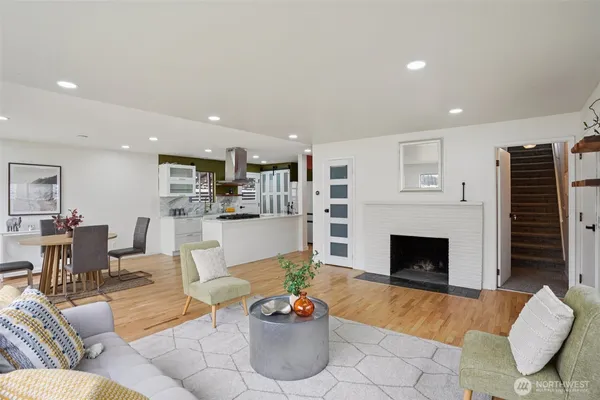 a living room with furniture a fireplace and a flat screen tv