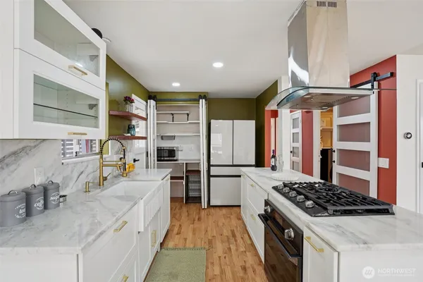 a kitchen with stainless steel appliances granite countertop a sink stove and refrigerator