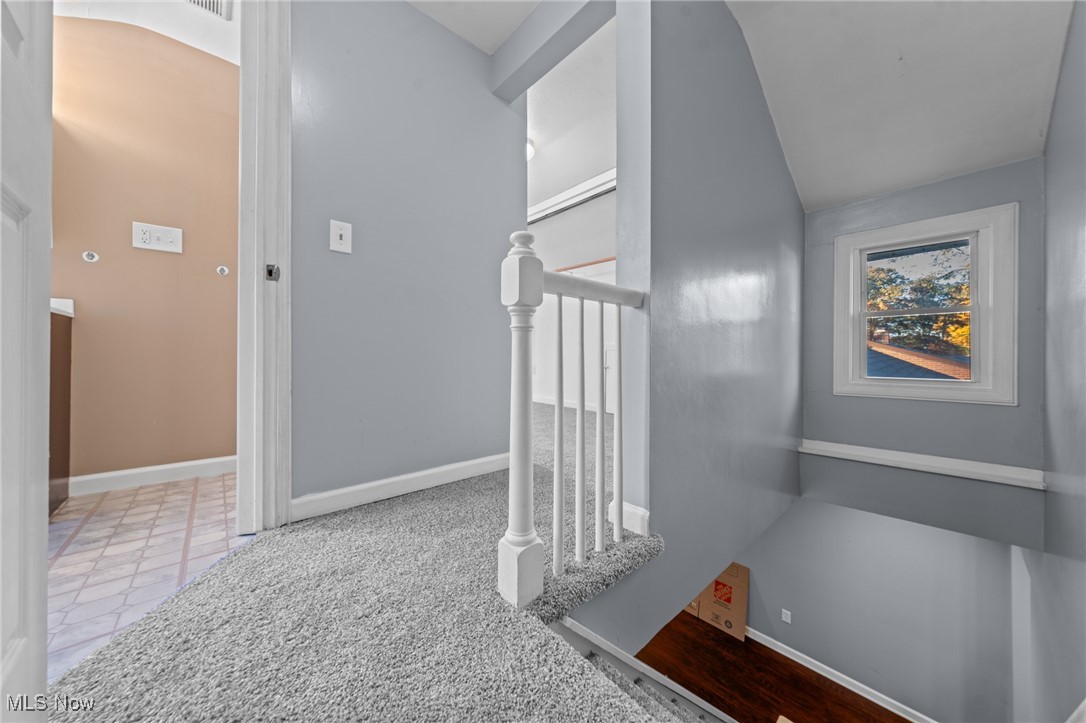 5865 Ruple Parkway Brook Park, OH 44142 - Photo 32 of 45 Stairs with lofted ceiling and tile patterned flooring