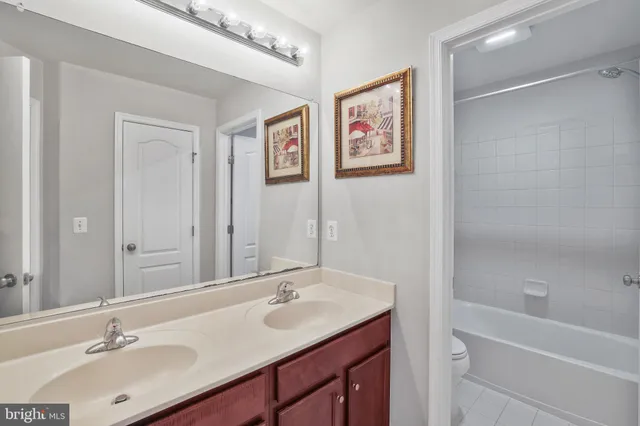 a bathroom with a double vanity sink and a mirror