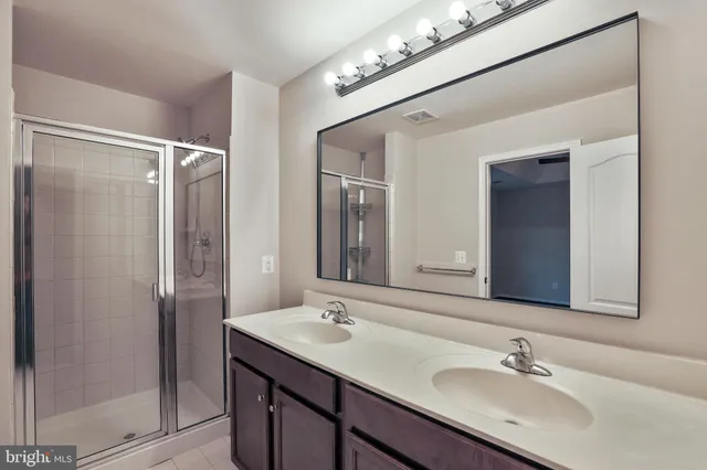 a bathroom with a sink double vanity and a mirror
