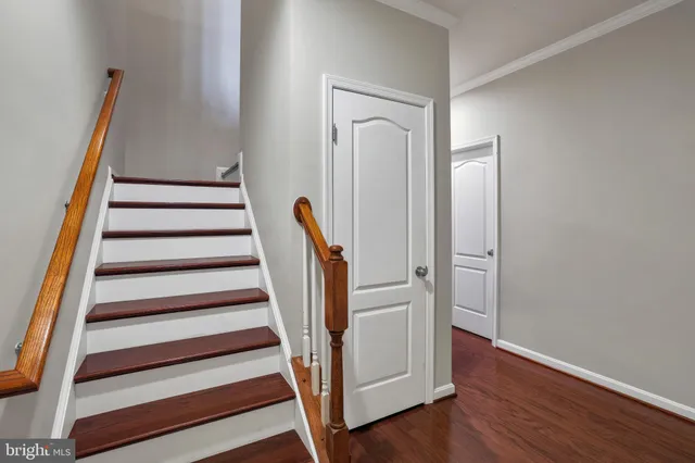a view of a hallway with wooden floor and entryway
