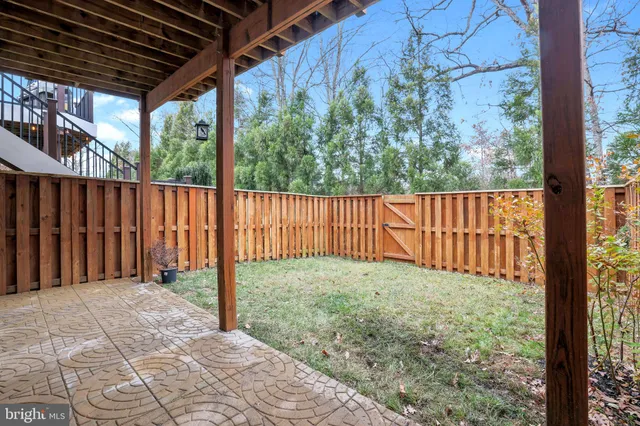 a view of a backyard with wooden fence