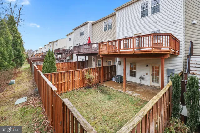 a balcony with tall trees in front of it