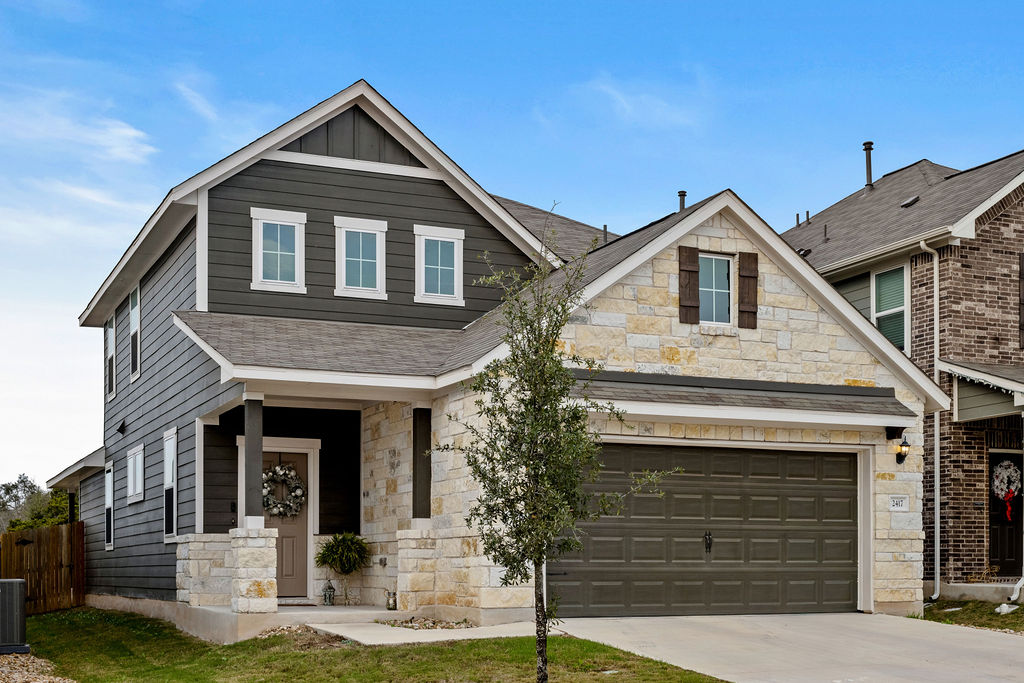 2417 Roosevelt Road Leander, TX 78641 - Photo 34 of 40 Craftsman inspired home featuring stone siding, concrete driveway, board and batten siding, and roof with shingles