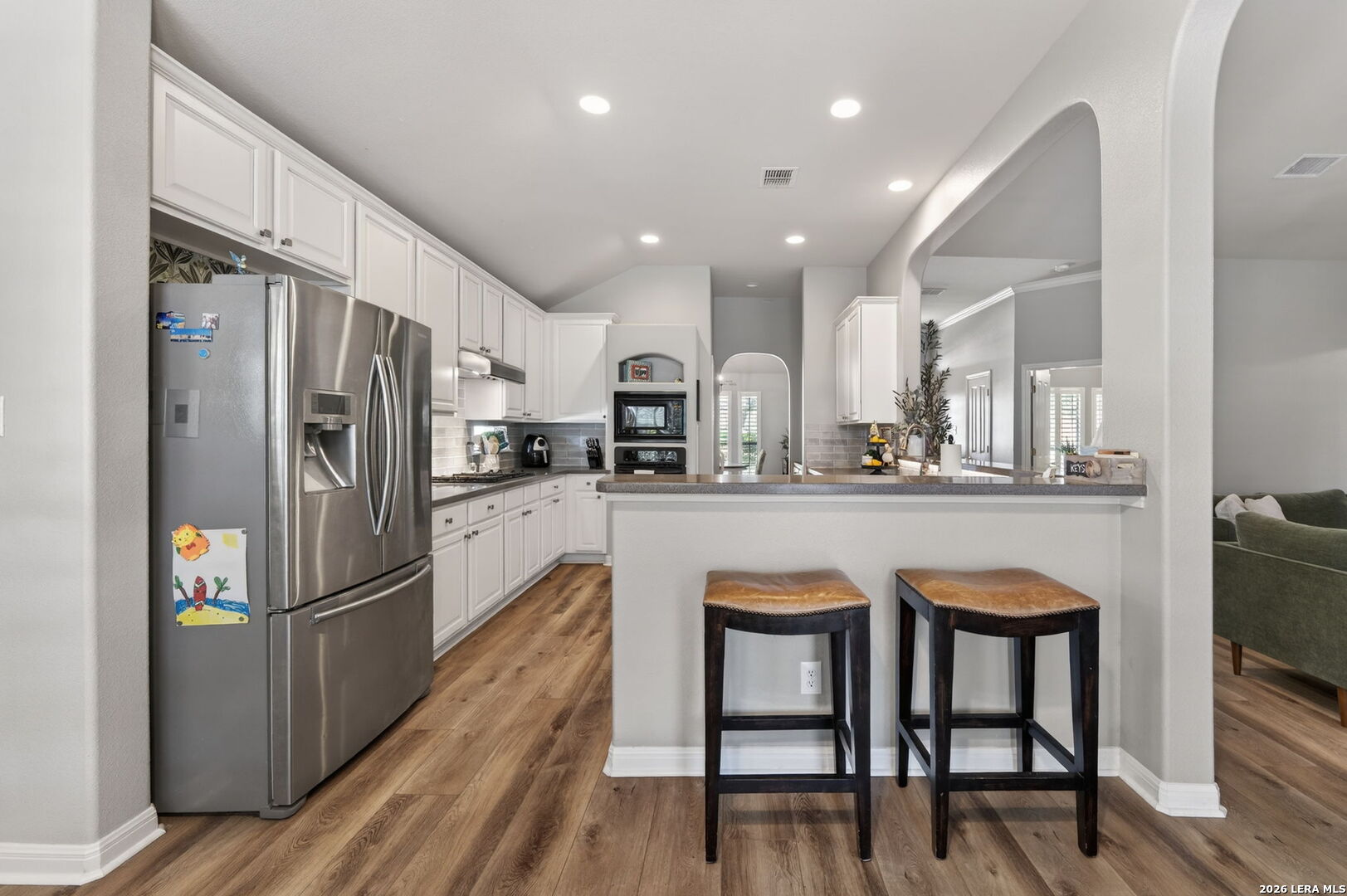 9514 Potters Point Helotes, TX 78023 - Photo 12 of 37 a kitchen with stainless steel appliances granite countertop a refrigerator and a stove top oven
