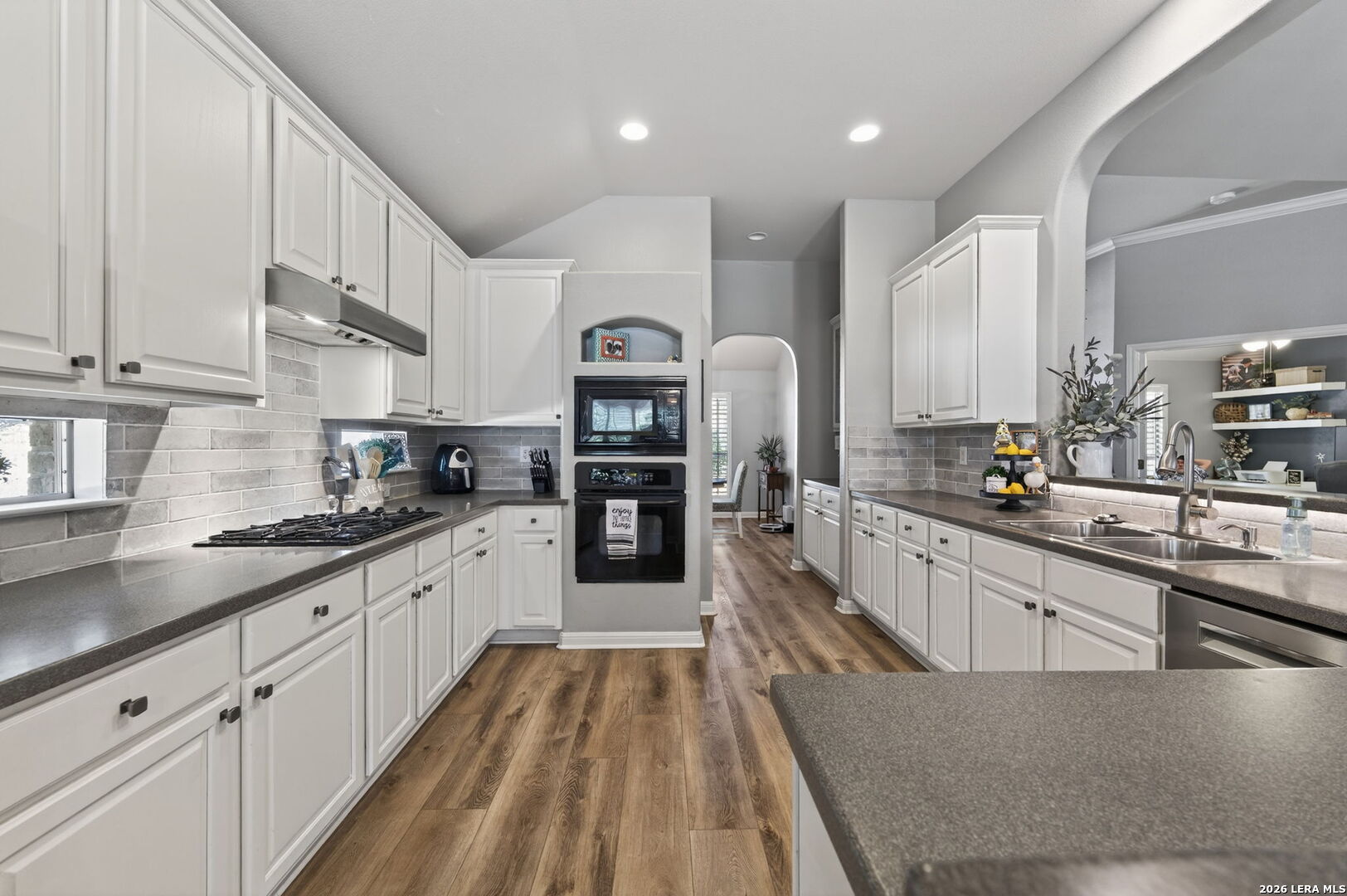 9514 Potters Point Helotes, TX 78023 - Photo 13 of 37 a large kitchen with stainless steel appliances granite countertop a lot of counter space and wooden floors
