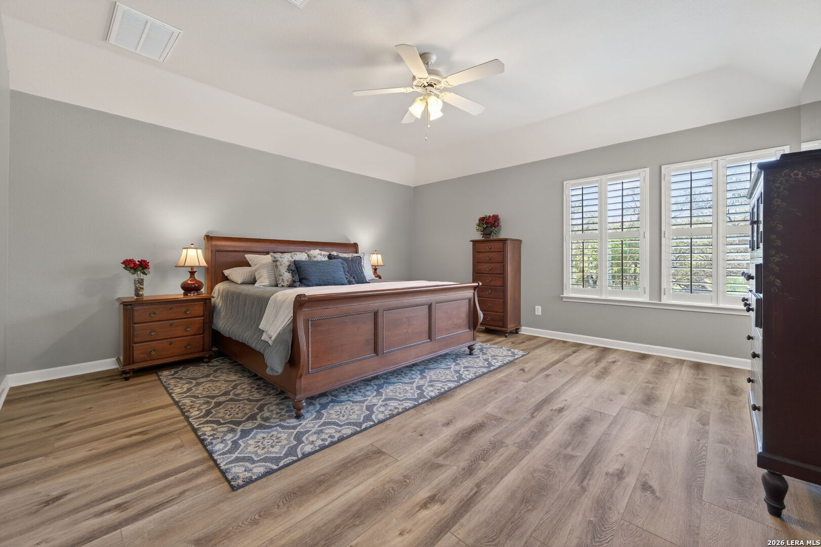 9514 Potters Point Helotes, TX 78023 - Photo 21 of 37 a bedroom with a bed and a large window with wooden floor