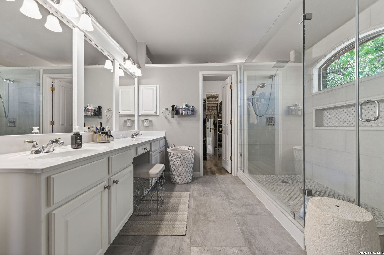 9514 Potters Point Helotes, TX 78023 - Photo 24 of 37 a bathroom with a double vanity sink toilet mirror and shower