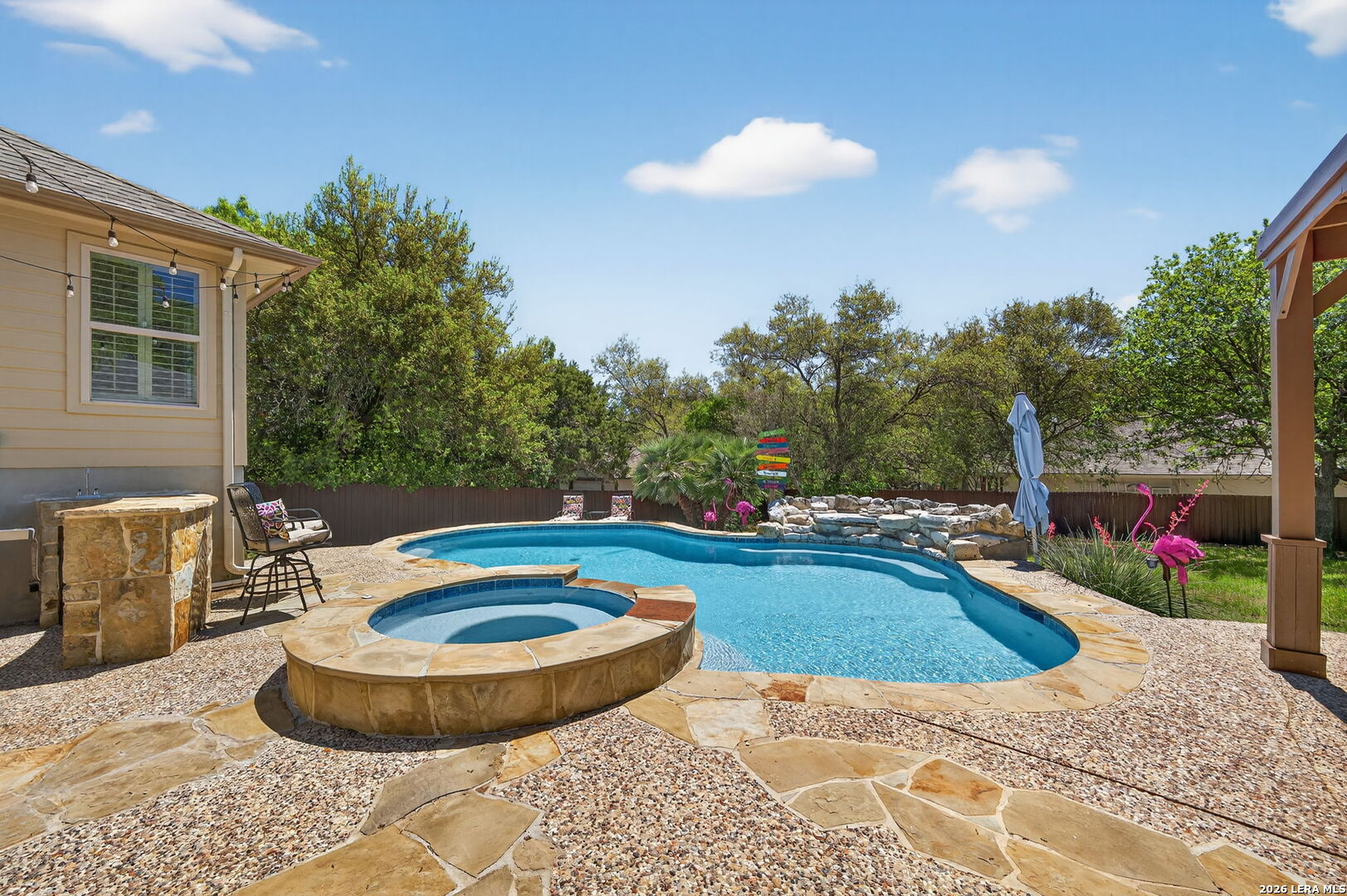 9514 Potters Point Helotes, TX 78023 - Photo 29 of 37 a view of a swimming pool with a chair and tables
