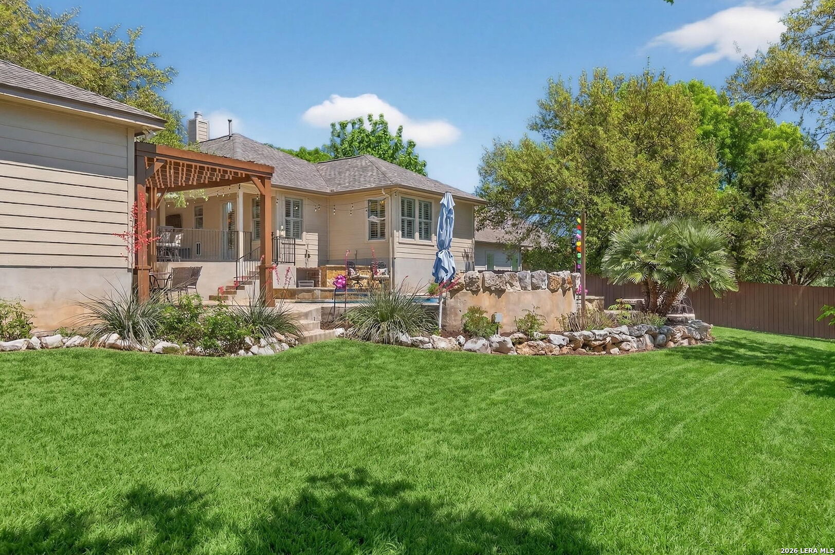 9514 Potters Point Helotes, TX 78023 - Photo 34 of 37 a front view of a house with a garden and plants