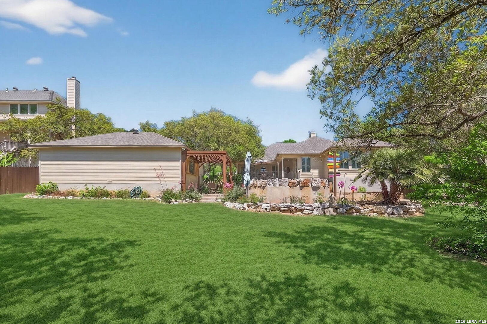 9514 Potters Point Helotes, TX 78023 - Photo 35 of 37 a front view of a house with a garden and trees