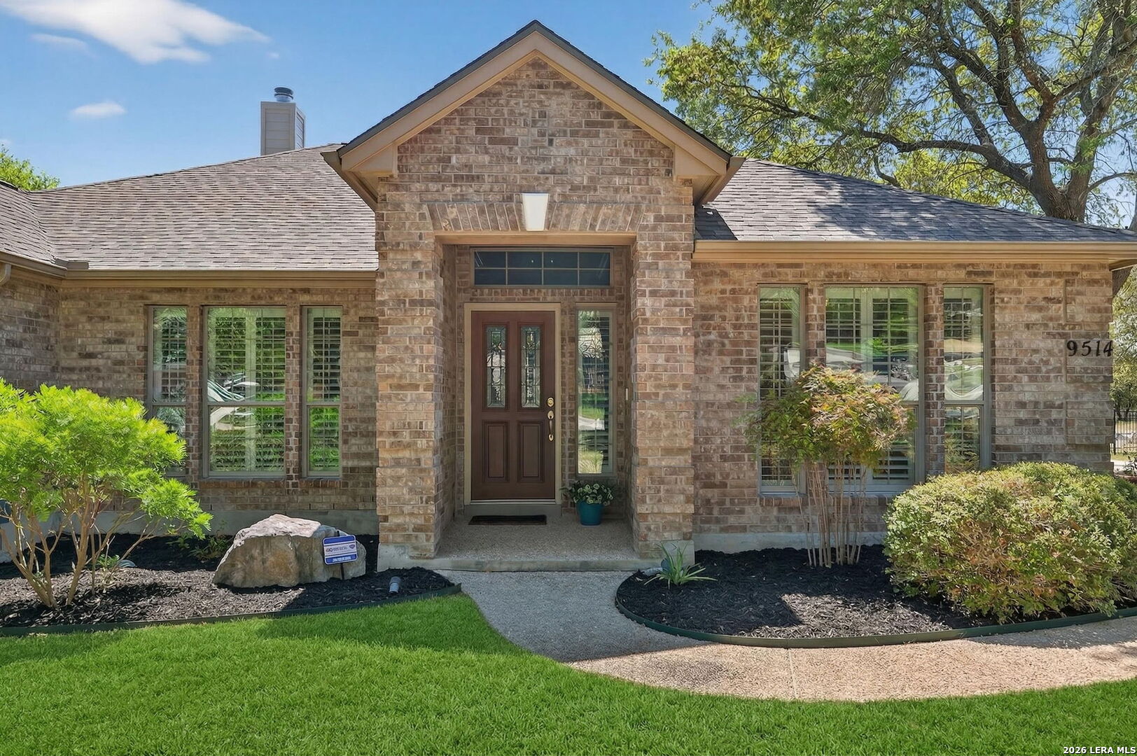 9514 Potters Point Helotes, TX 78023 - Photo 5 of 37 a front view of a house with garden