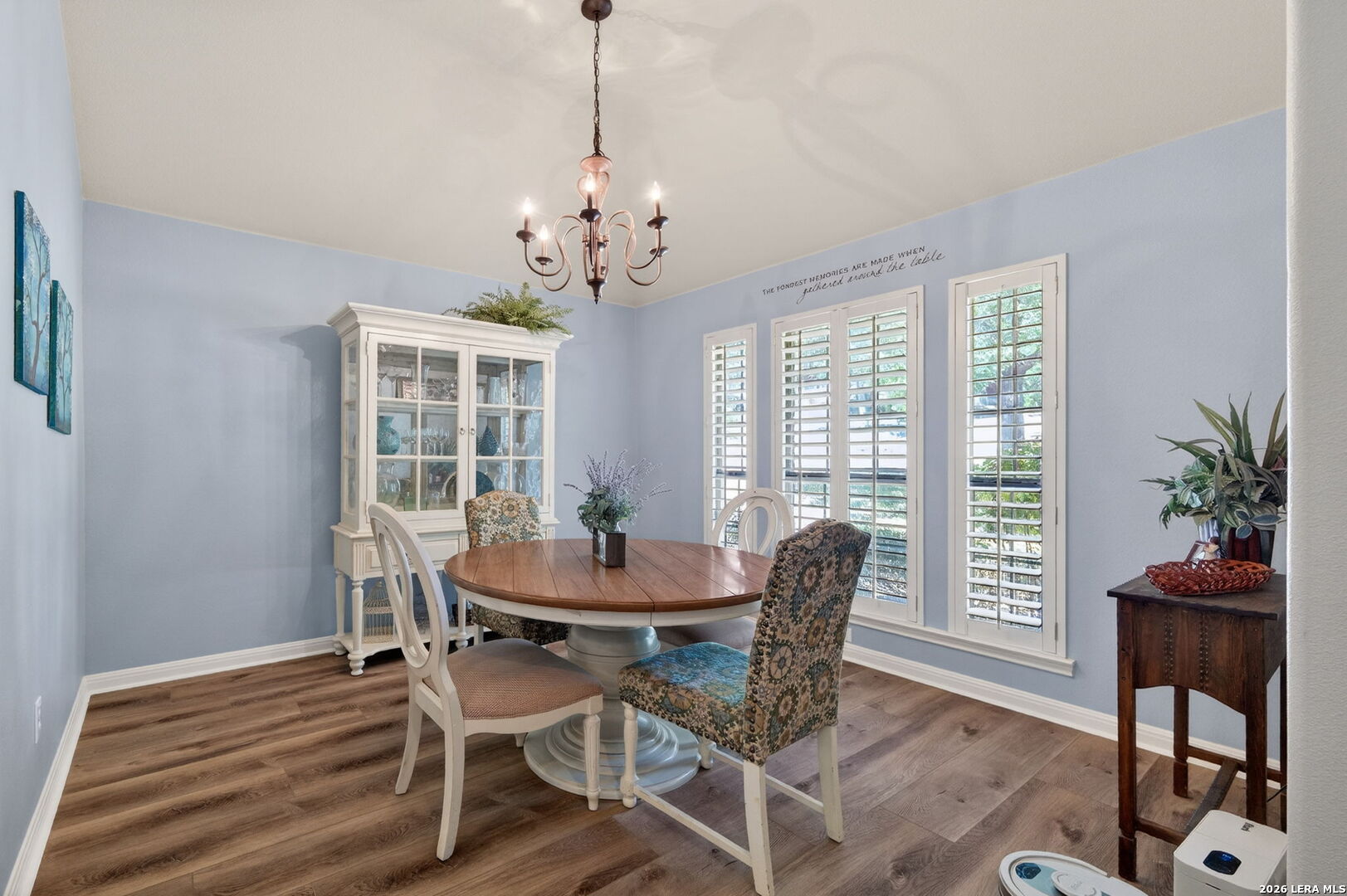 9514 Potters Point Helotes, TX 78023 - Photo 7 of 37 a dining room with furniture a chandelier and wooden floor