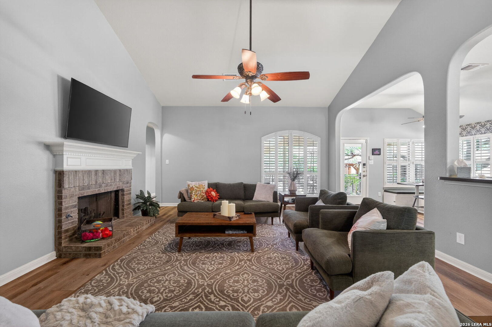 9514 Potters Point Helotes, TX 78023 - Photo 9 of 37 a living room with furniture a fireplace and a flat screen tv