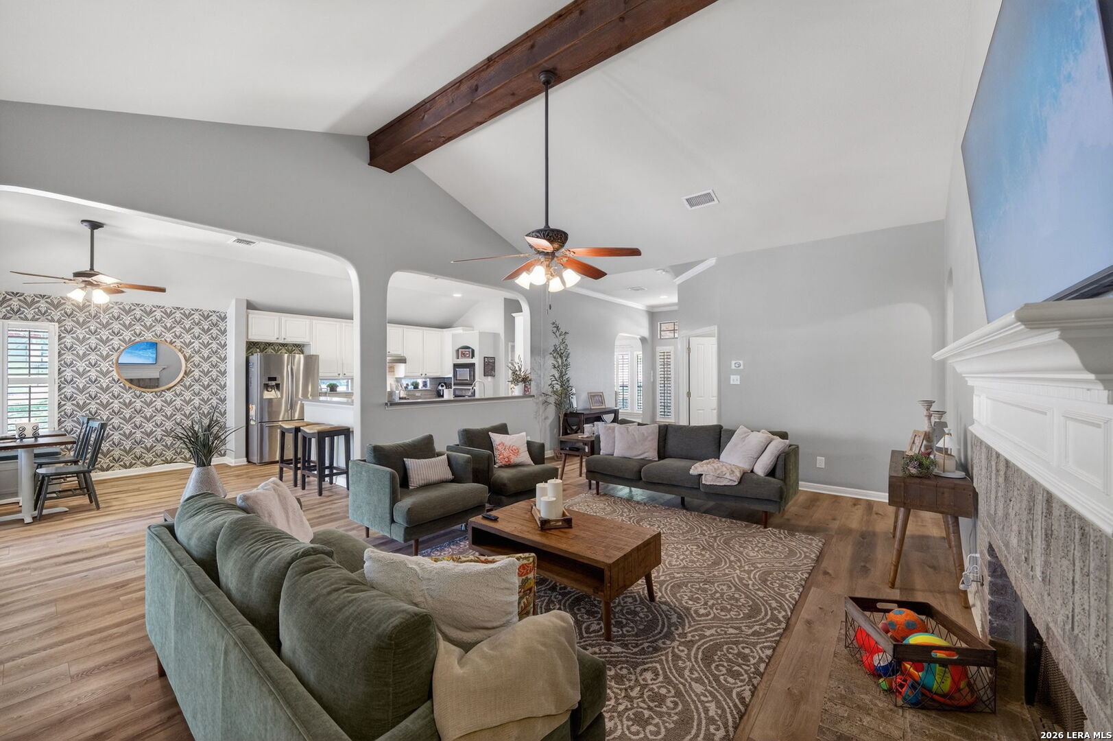 9514 Potters Point Helotes, TX 78023 - Photo 10 of 37 a living room with furniture a fireplace and a chandelier