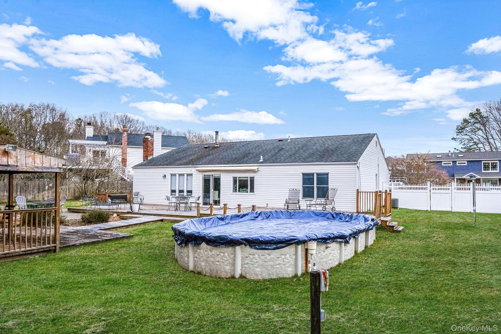 32 San Rafael Avenue Holbrook, NY 11741 - Photo 16 of 44 a view of a house with a backyard porch and sitting area