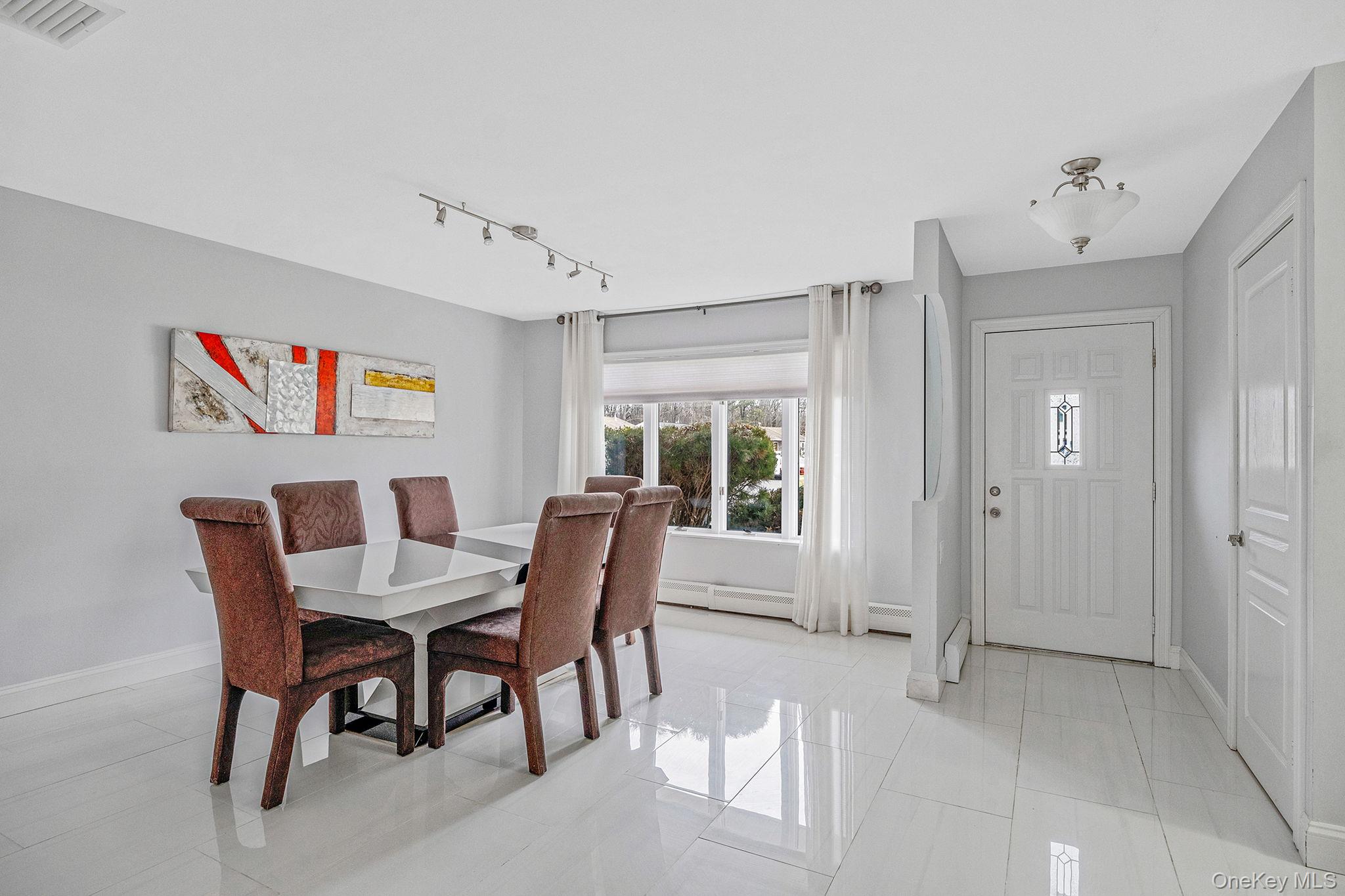 32 San Rafael Avenue Holbrook, NY 11741 - Photo 20 of 44 a view of a dining room with furniture window and outside view