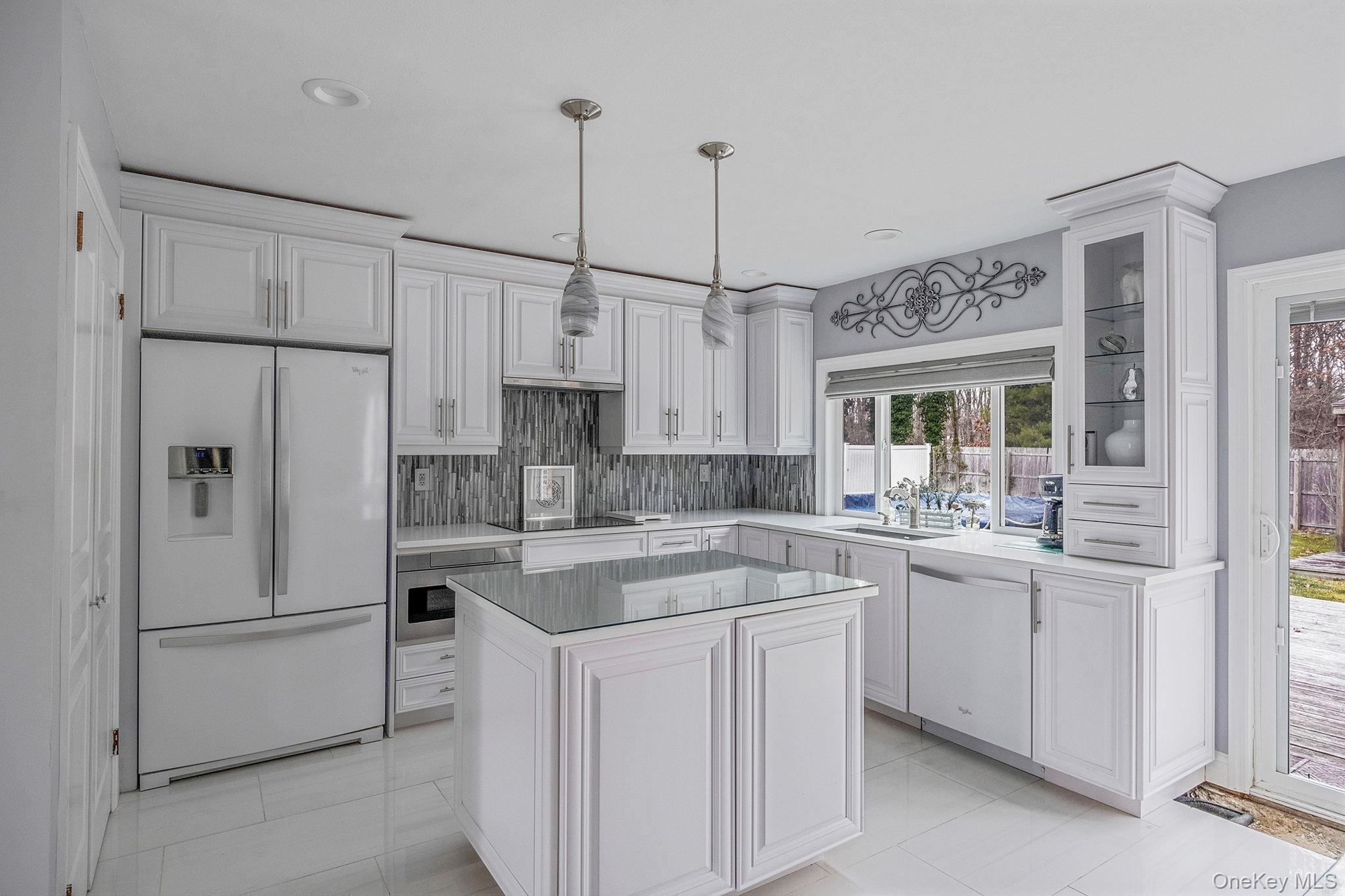 32 San Rafael Avenue Holbrook, NY 11741 - Photo 22 of 44 a kitchen with white cabinets and white appliances