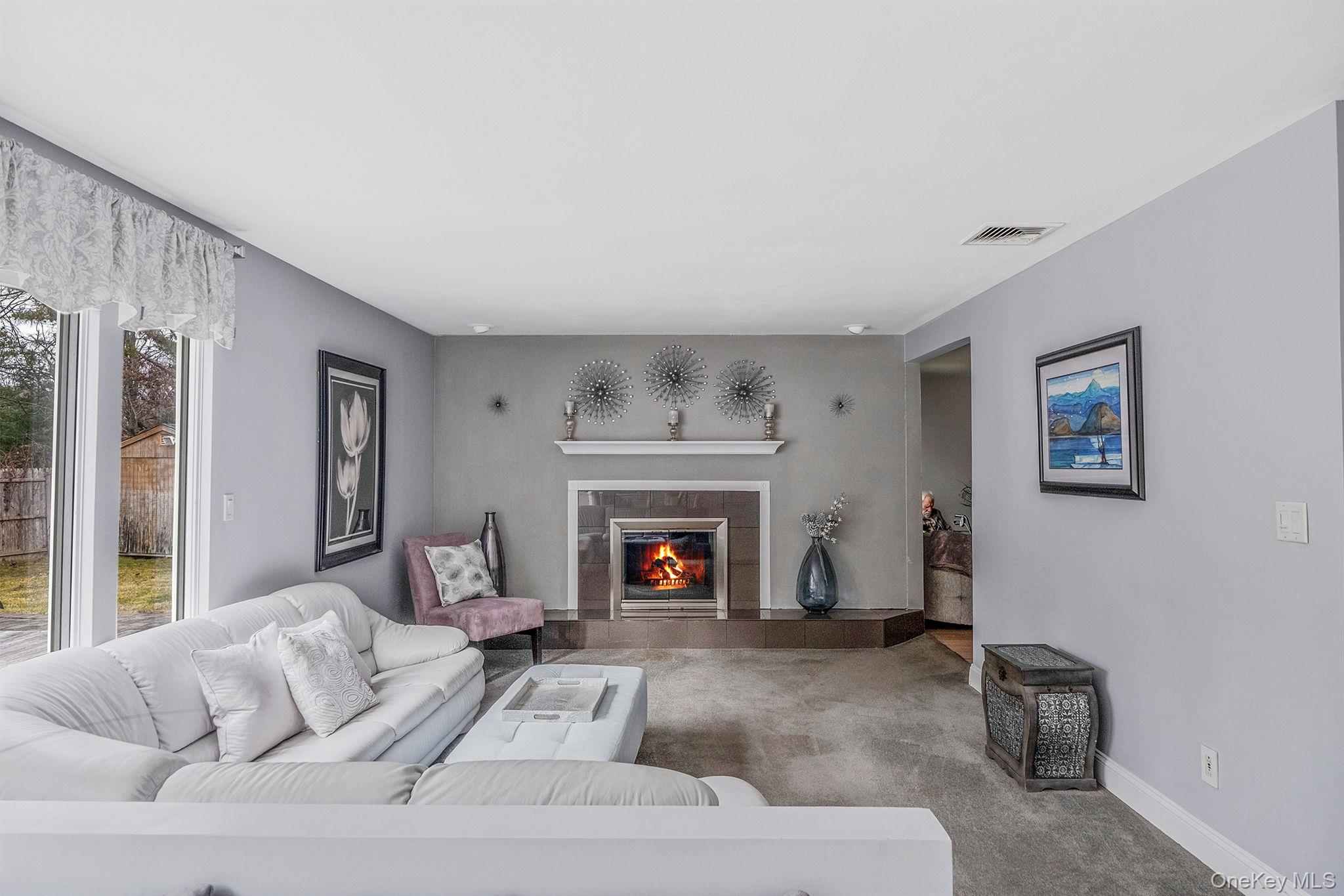 32 San Rafael Avenue Holbrook, NY 11741 - Photo 29 of 44 a living room with furniture and a fireplace