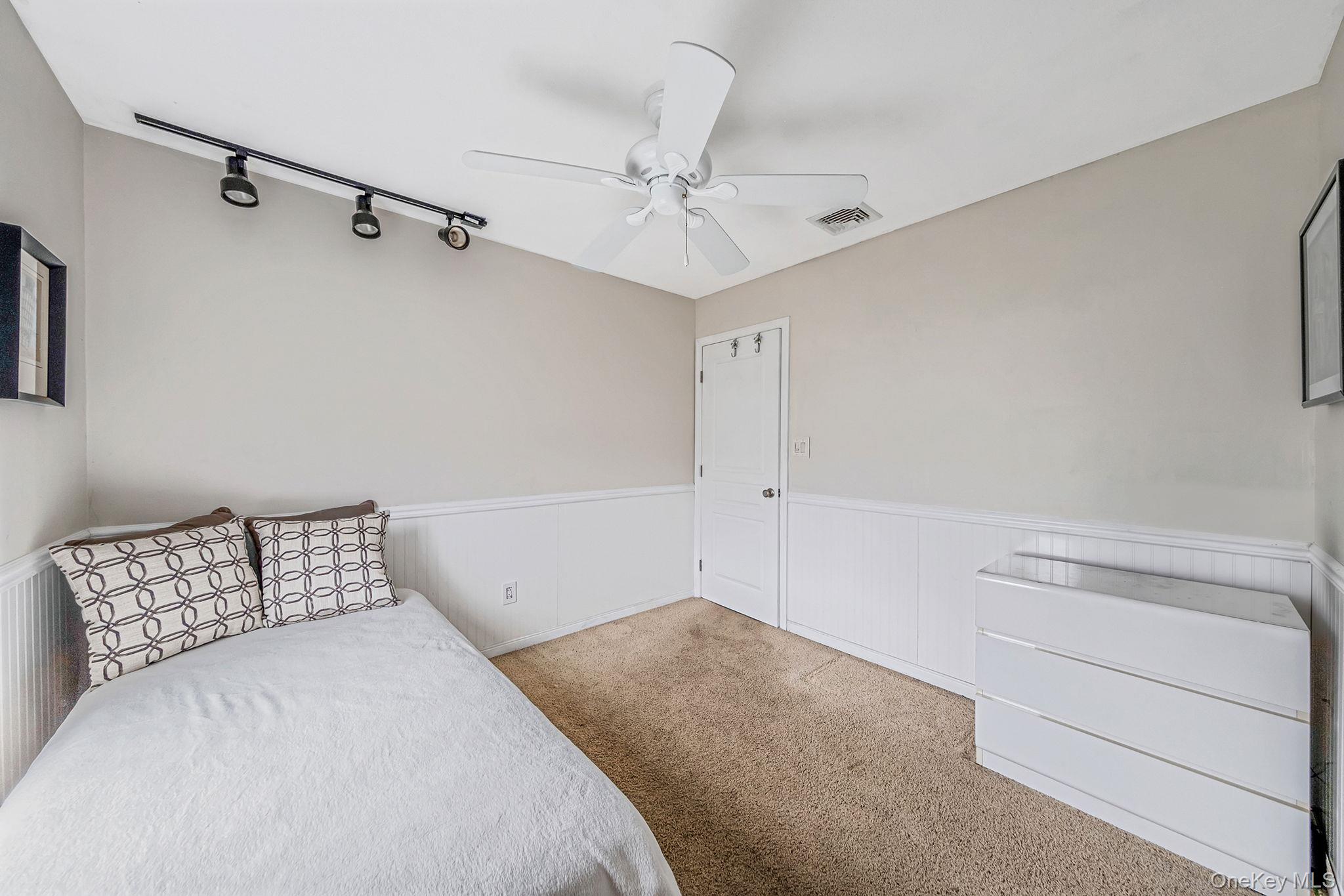 32 San Rafael Avenue Holbrook, NY 11741 - Photo 38 of 44 a bedroom with a bed and a ceiling fan