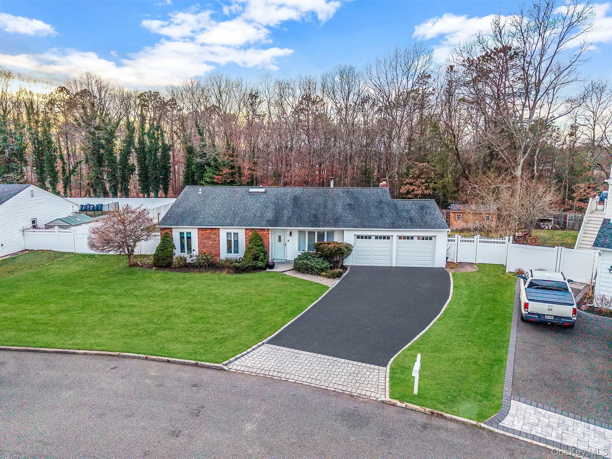 32 San Rafael Avenue Holbrook, NY 11741 - Photo 5 of 44 a view of a house with a garden and trees