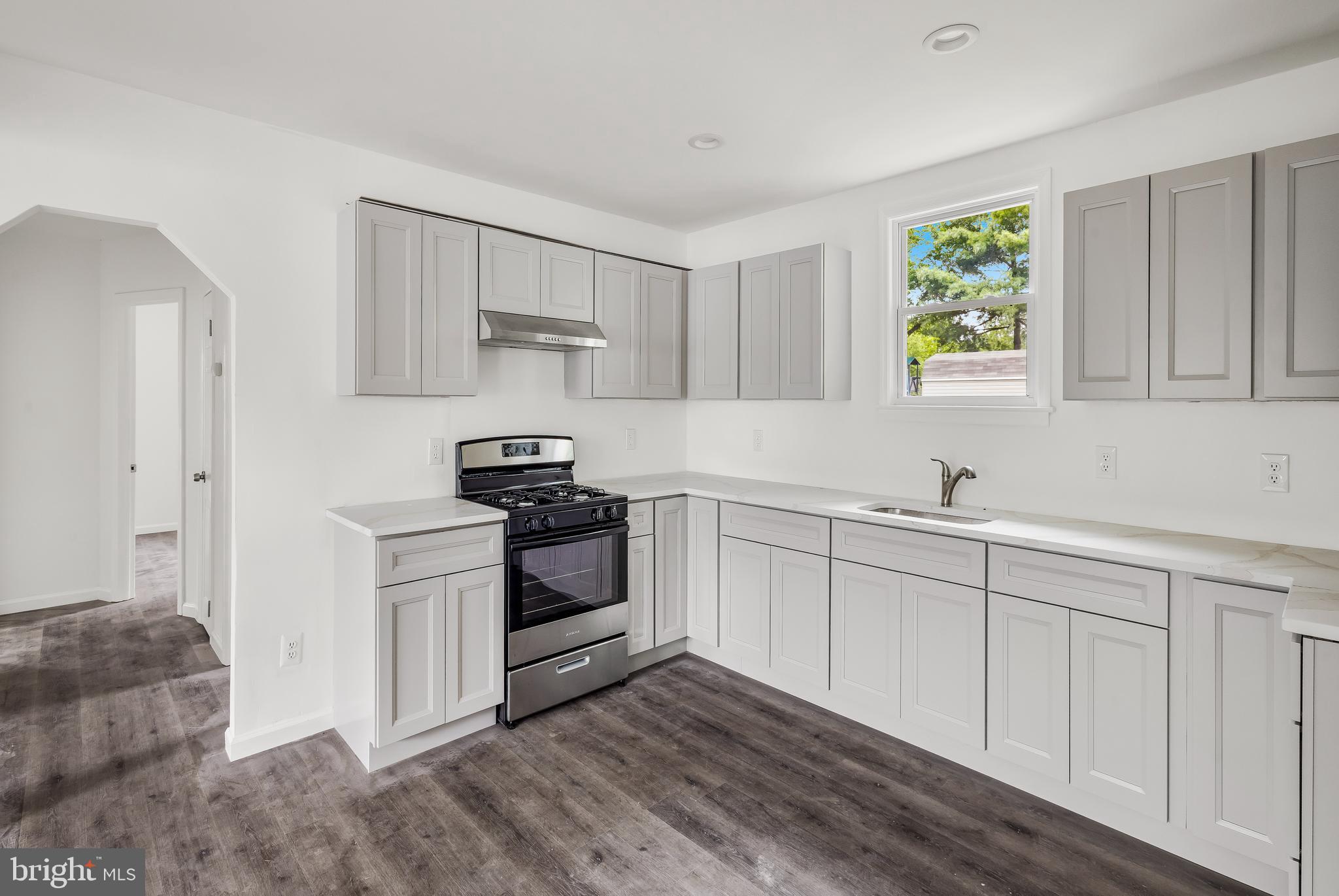 505 West Evesham Road, Unit A Glendora, NJ 08029 - Photo 4 of 11 a kitchen with stainless steel appliances white cabinets a sink a stove a refrigerator and a window