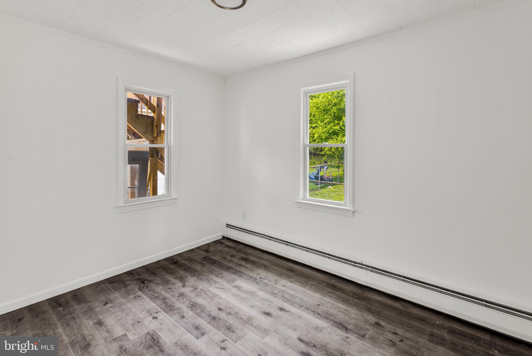 505 West Evesham Road, Unit A Glendora, NJ 08029 - Photo 9 of 11 a view of an empty room with window and wooden floor