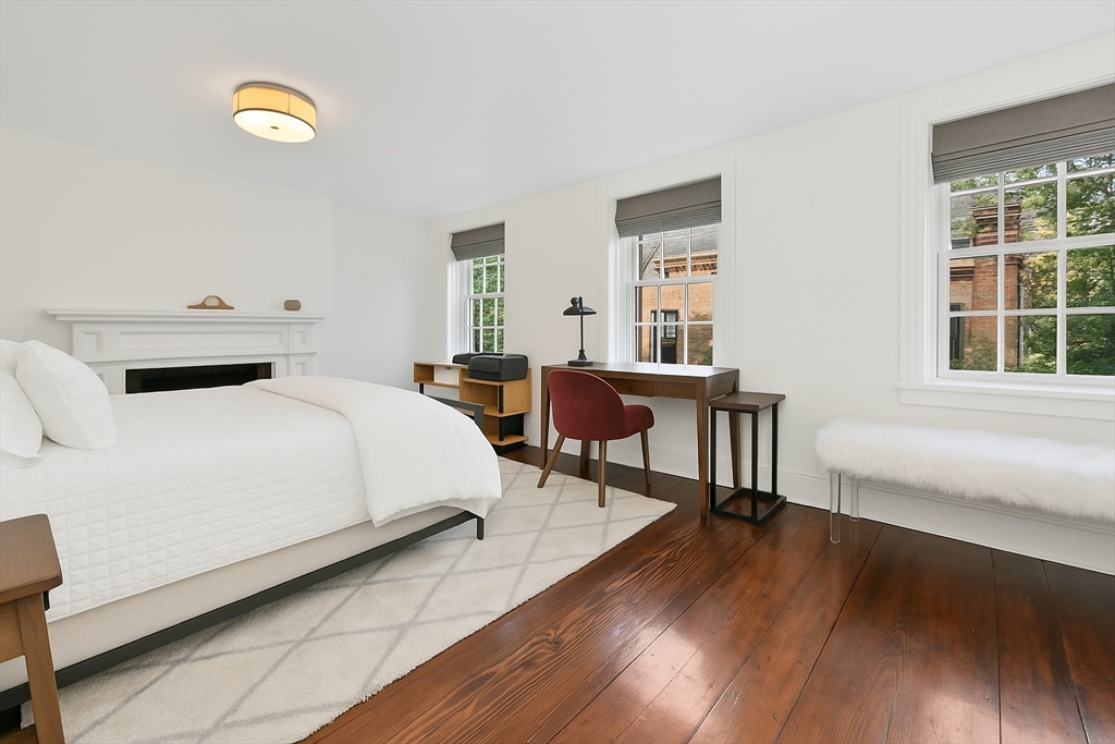 6 Strong Place Boston, MA 02114 - Photo 19 of 25 a bedroom with a bed and a desk