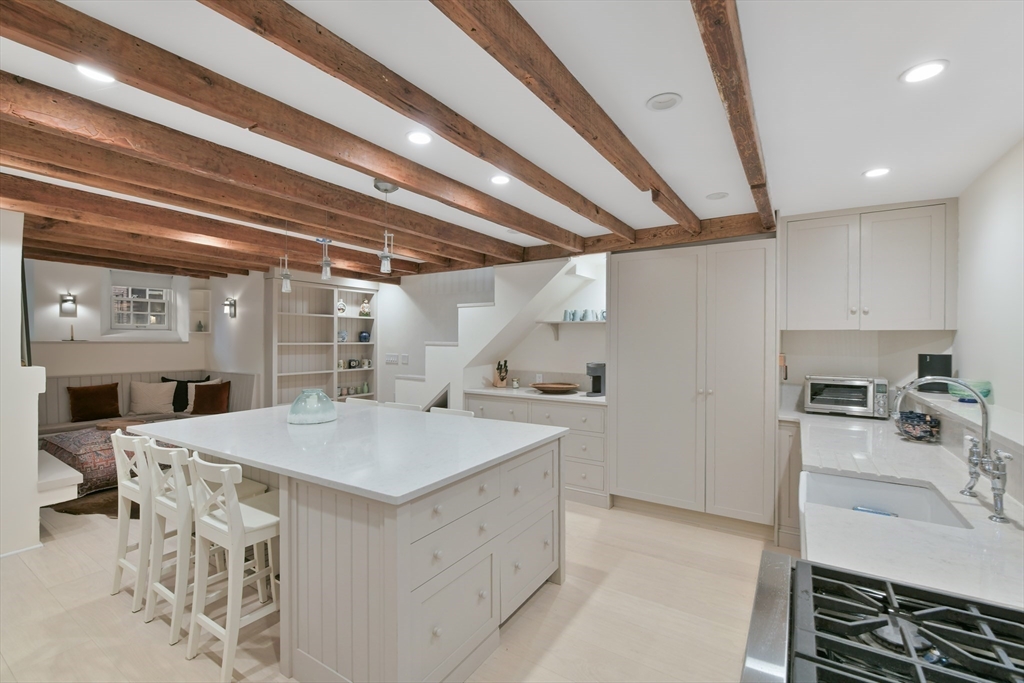 6 Strong Place Boston, MA 02114 - Photo 8 of 25 a kitchen with a sink appliances and cabinets