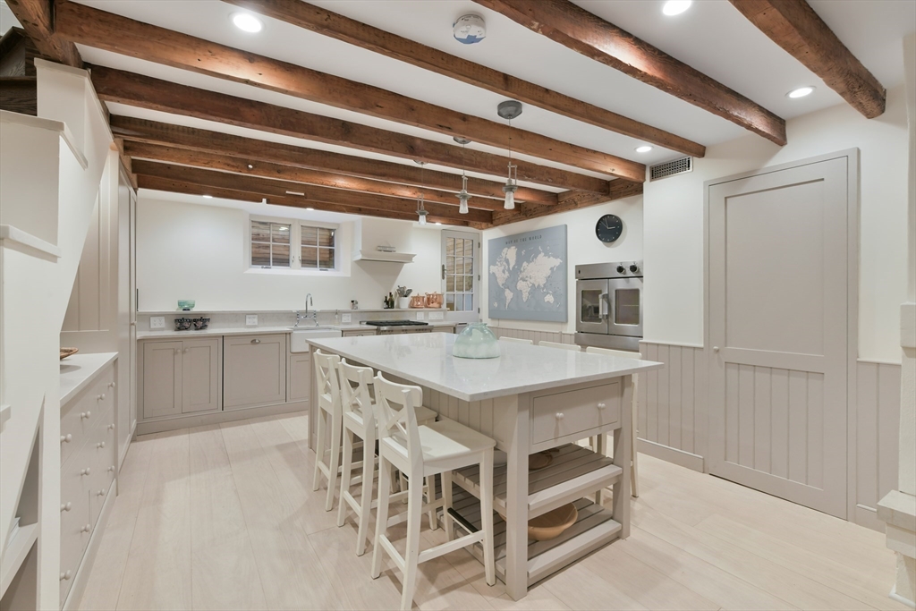 6 Strong Place Boston, MA 02114 - Photo 9 of 25 a kitchen with a table and chairs
