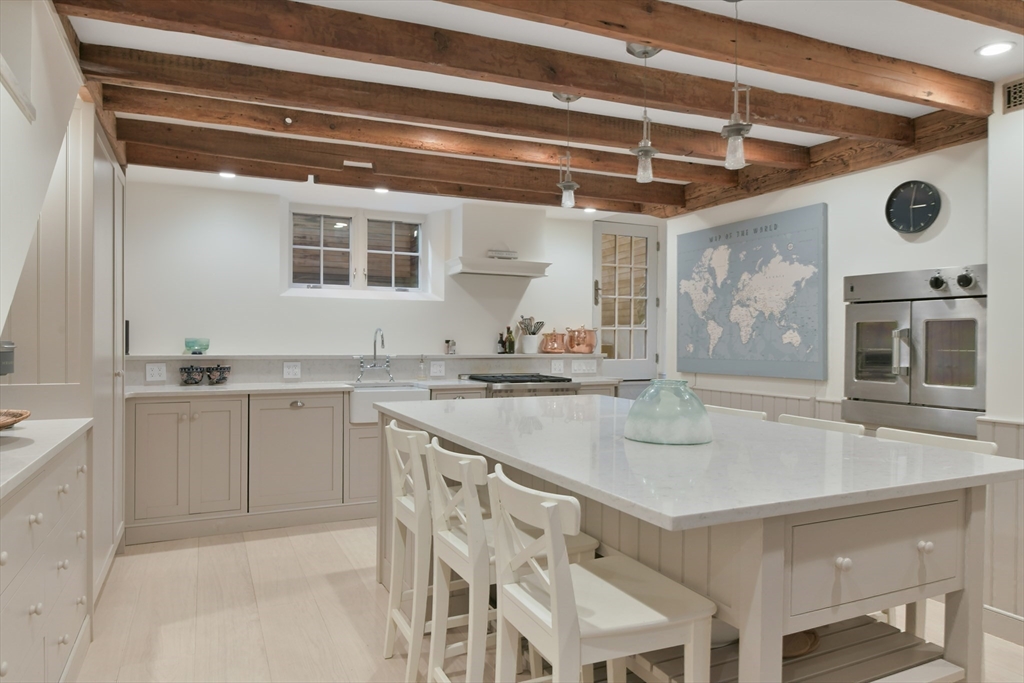 6 Strong Place Boston, MA 02114 - Photo 10 of 25 a kitchen with granite countertop a sink and a stove top oven