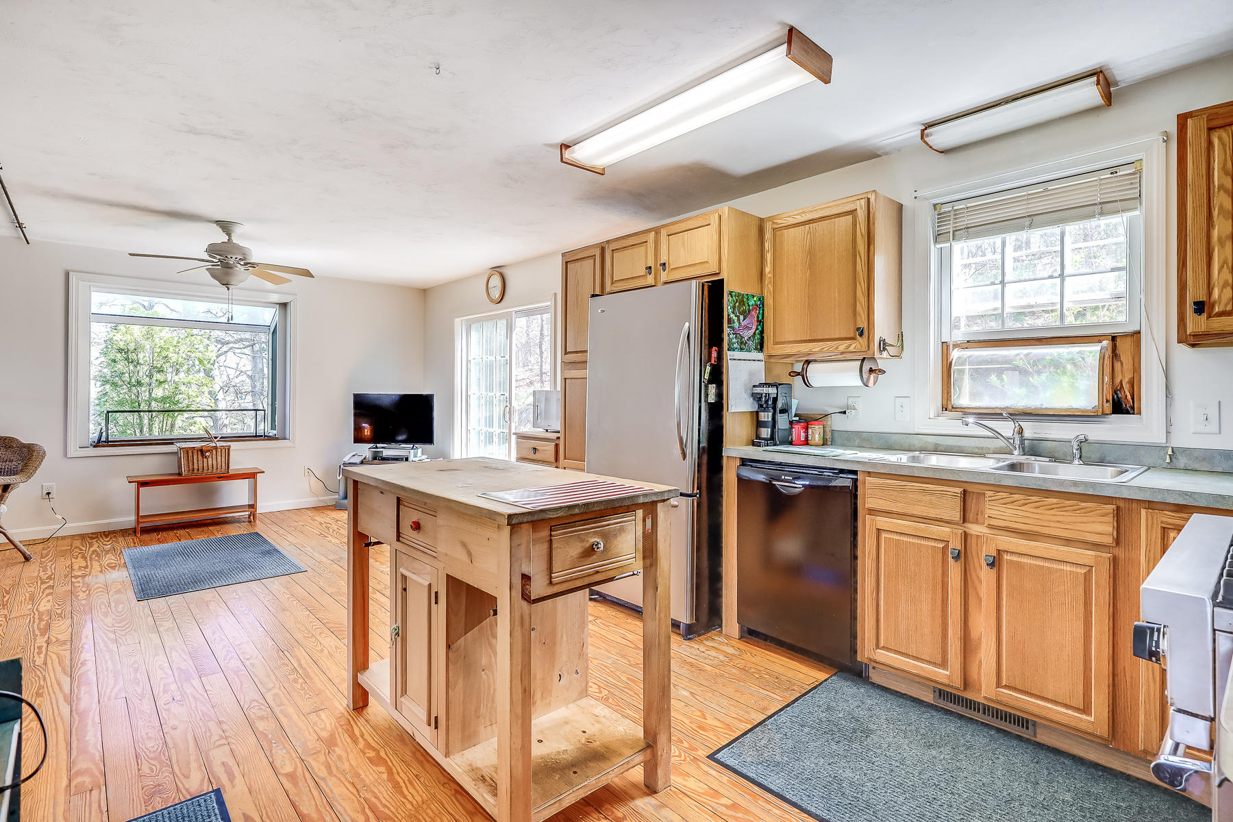 202 Northgate Road North Chatham, MA 02633 - Photo 22 of 34 a kitchen with stainless steel appliances granite countertop a refrigerator a stove a sink dishwasher and white cabinets with wooden floor