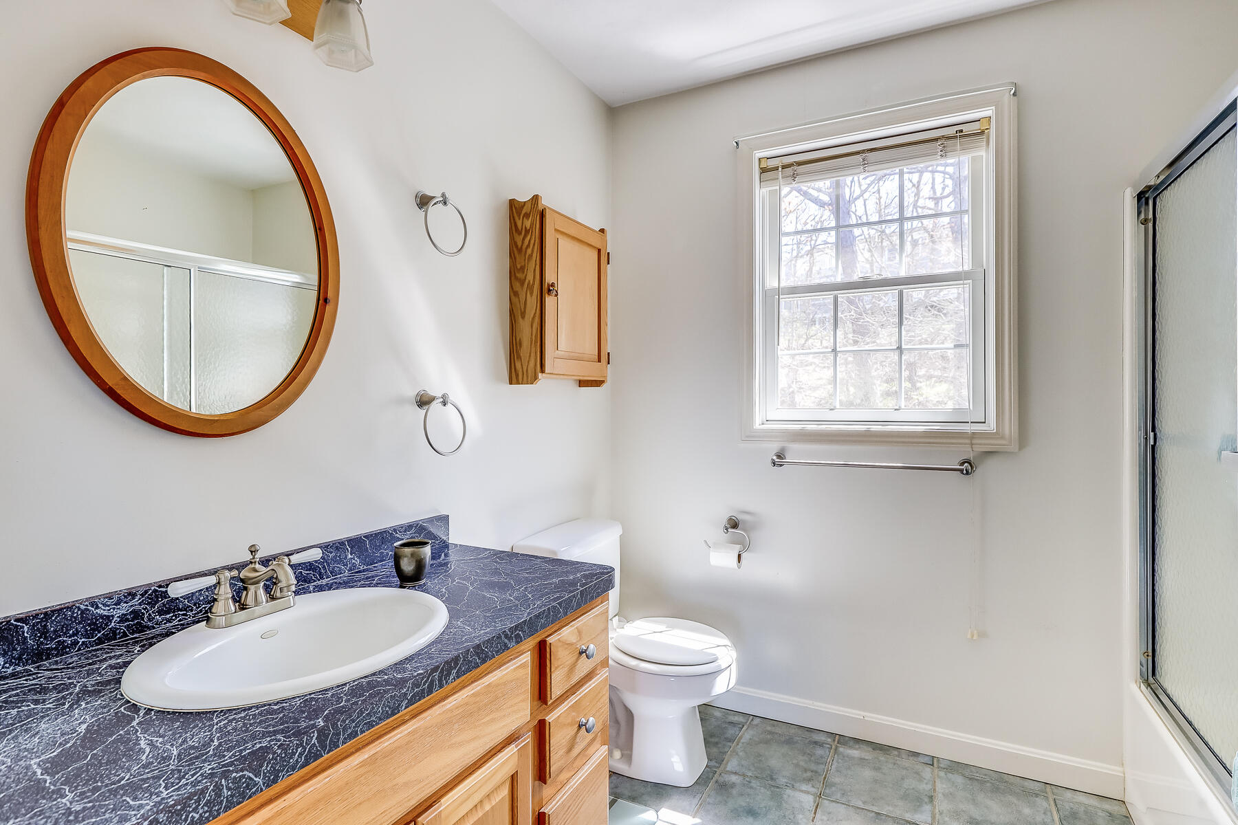 202 Northgate Road North Chatham, MA 02633 - Photo 28 of 34 a bathroom with a granite countertop toilet a sink a mirror and a window