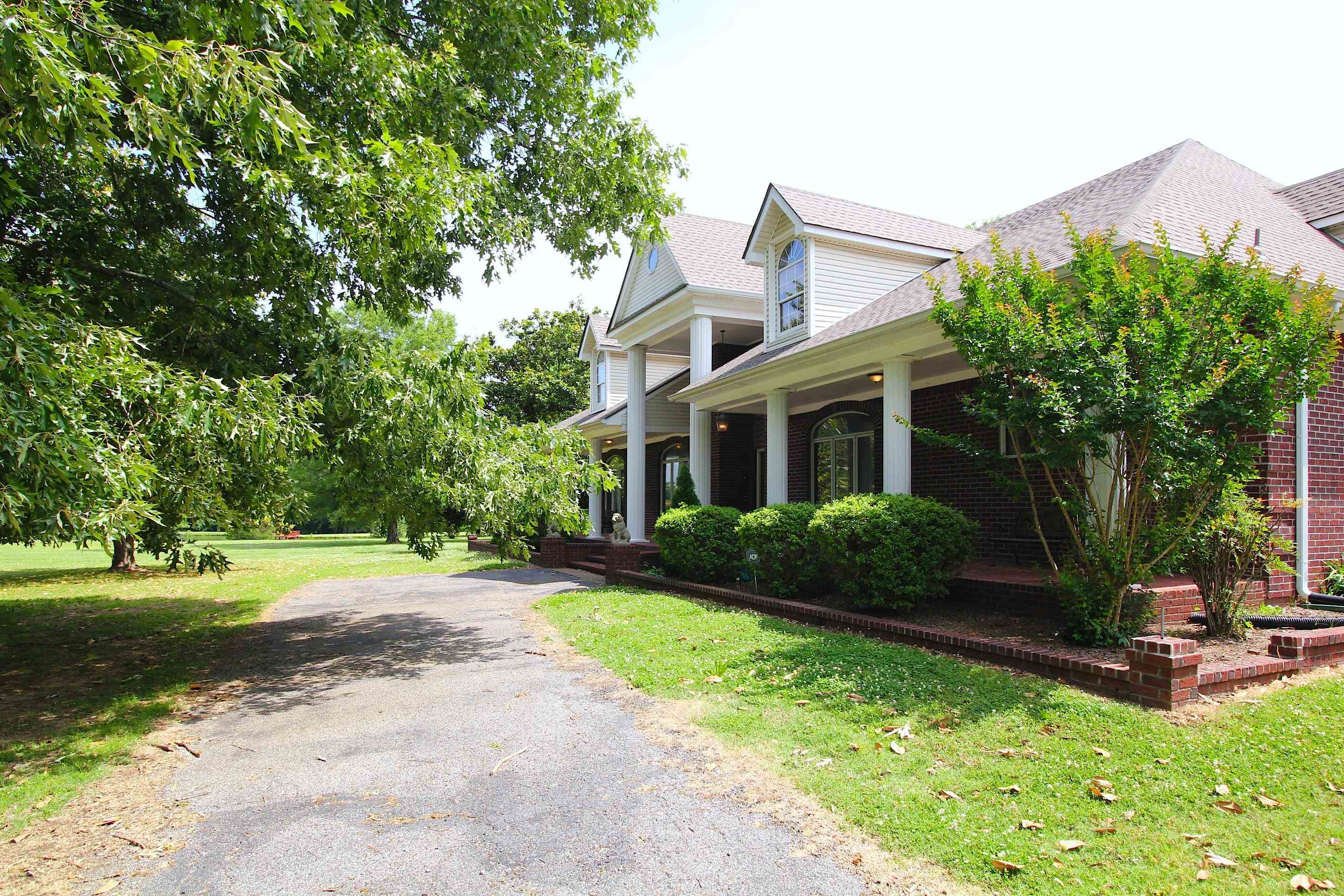 2550 North Reid Hooker Road Eads, TN 38028 - Photo 2 of 32 a front view of a house with garden and trees