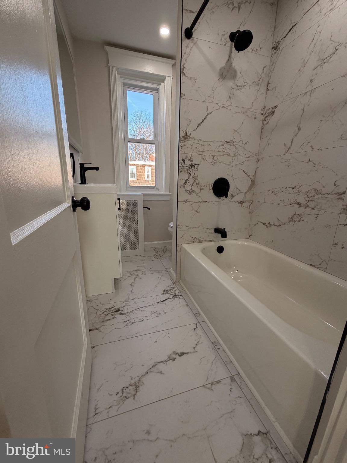 641 Copley Road Upper Darby, PA 19082 - Photo 18 of 29 Elegant marble bath with modern fixtures.